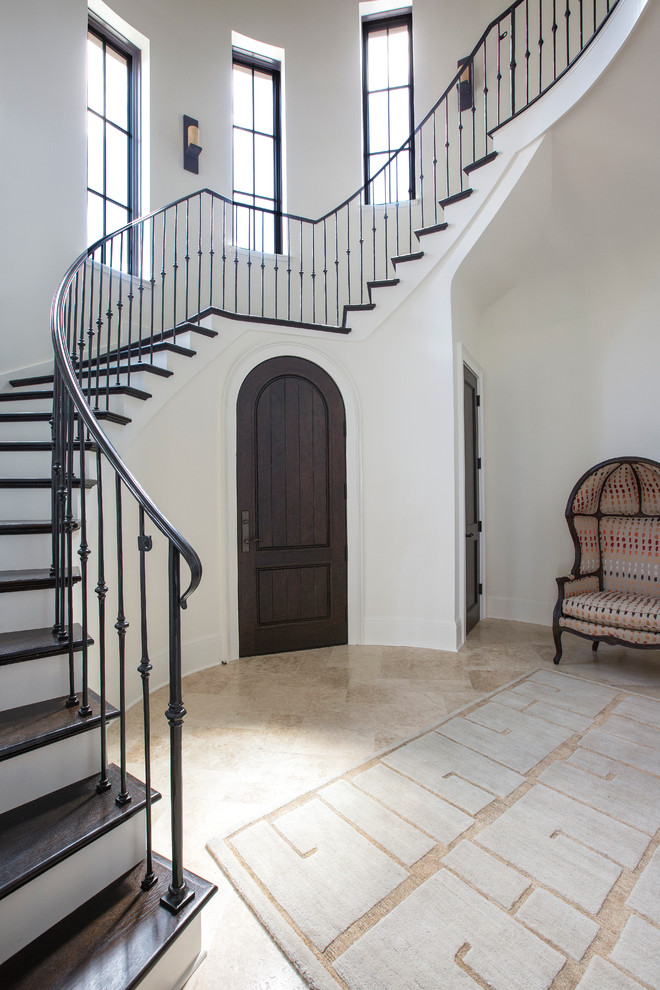 Example of a large transitional wooden curved staircase design in Jacksonville with painted risers
