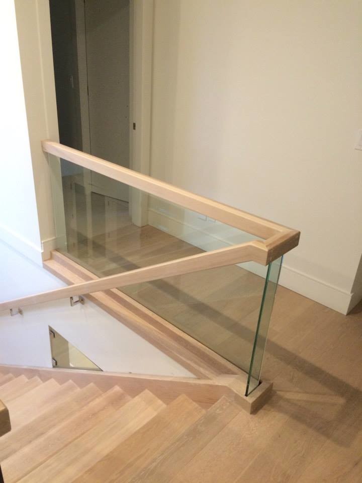 This is an example of a large contemporary wood straight mixed railing staircase in Vancouver with open risers.