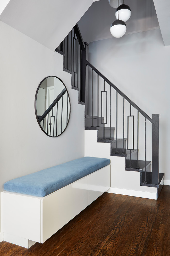 Trendy wooden u-shaped metal railing staircase photo in New York with wooden risers