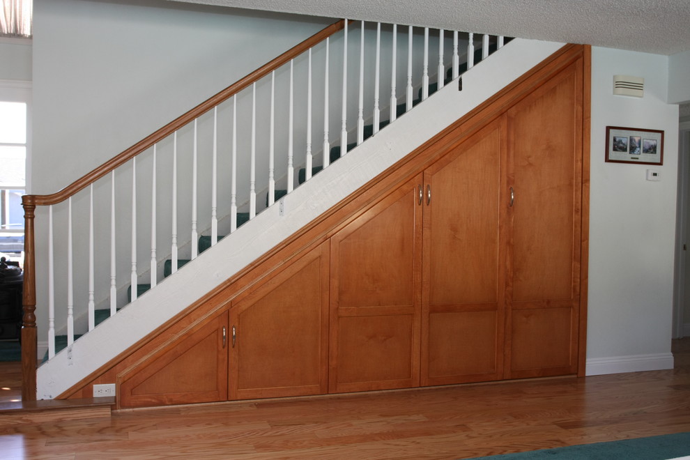 Design ideas for a traditional staircase in Orange County with under stair storage.