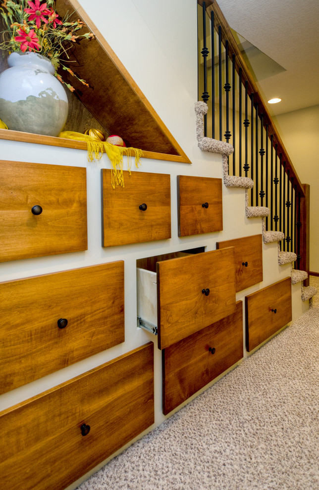 На фото: лестница в классическом стиле с ступенями с ковровым покрытием, ковровыми подступенками и кладовкой или шкафом под ней с