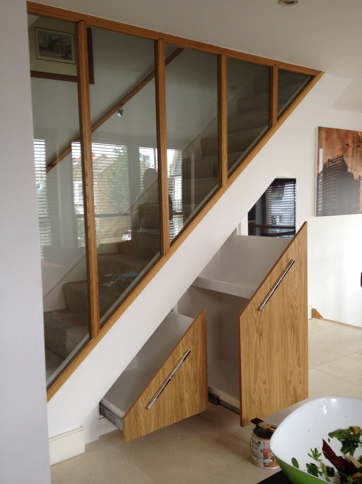 This is an example of a contemporary staircase in Other with under stair storage.