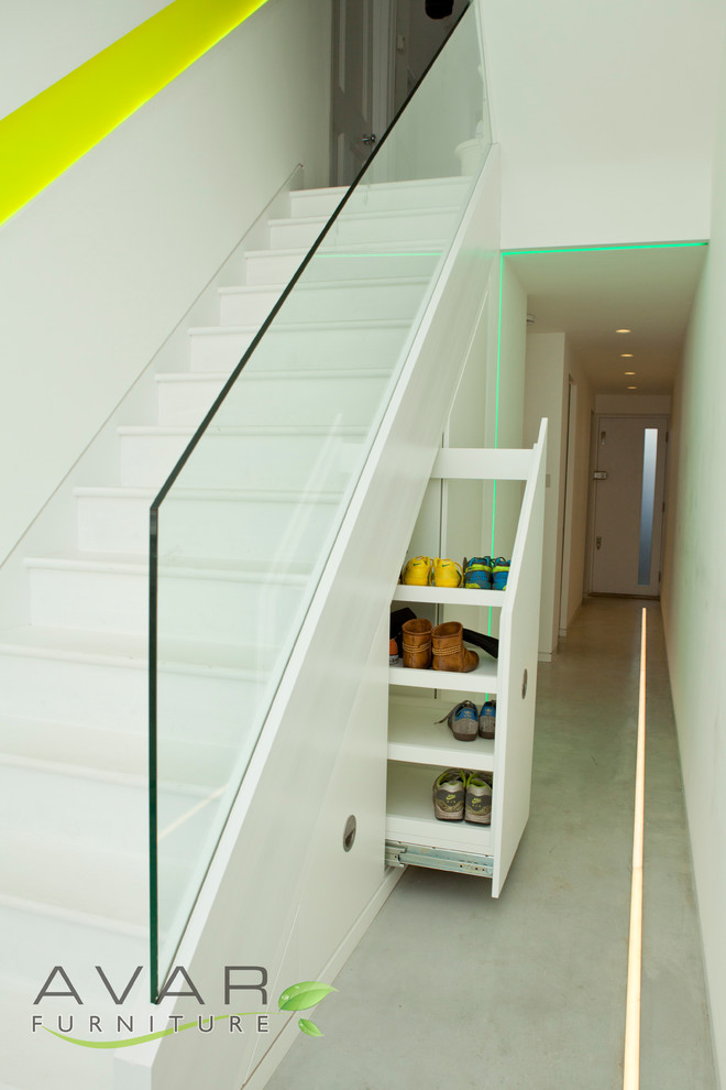 Contemporary staircase in London with under stair storage.