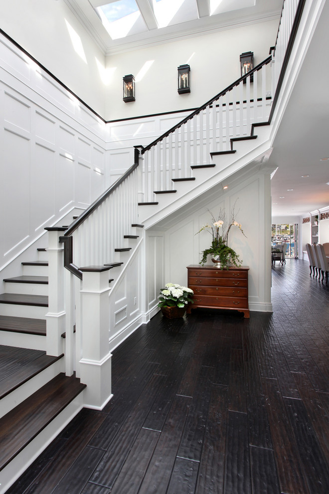 Staircase - coastal wooden staircase idea in Orange County with wooden risers