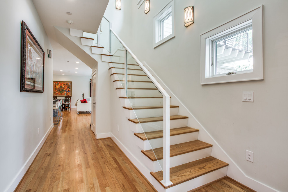 Стильный дизайн: угловая лестница среднего размера в современном стиле с деревянными ступенями, крашенными деревянными подступенками и стеклянными перилами - последний тренд