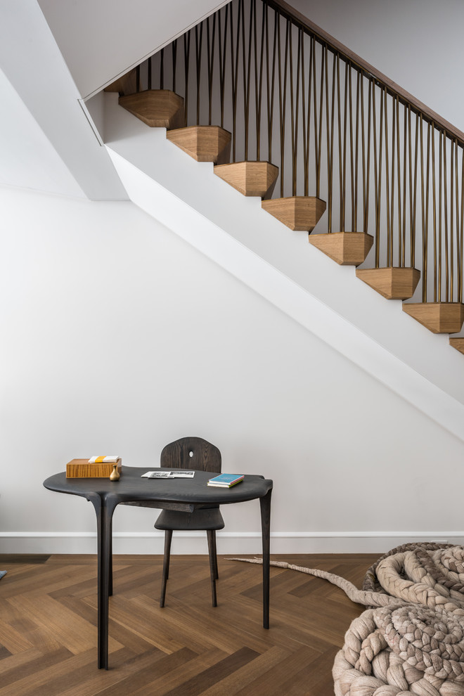 Photo of a large modern wood u-shaped mixed railing staircase in New York with wood risers.