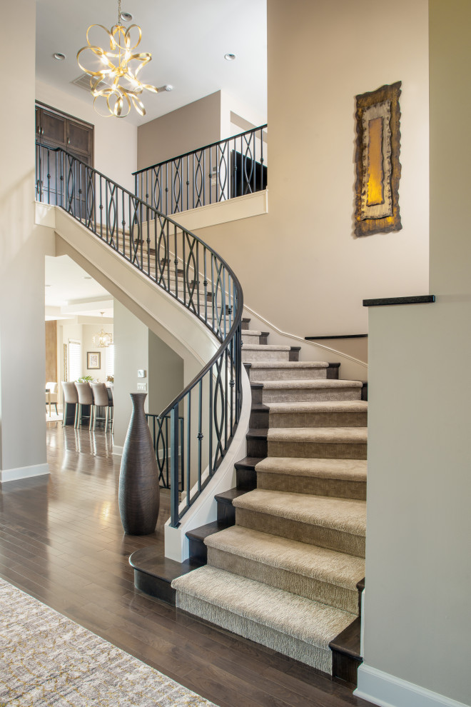 Design ideas for a medium sized traditional carpeted curved mixed railing staircase in Omaha with carpeted risers.