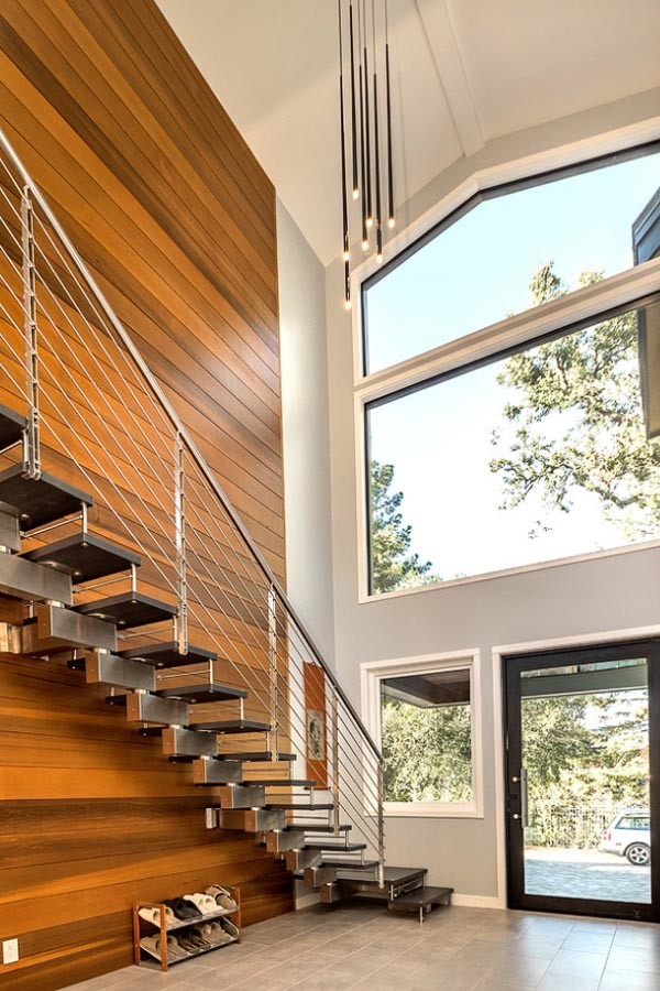 Photo of a large contemporary wood floating wire cable railing staircase in San Francisco with open risers.
