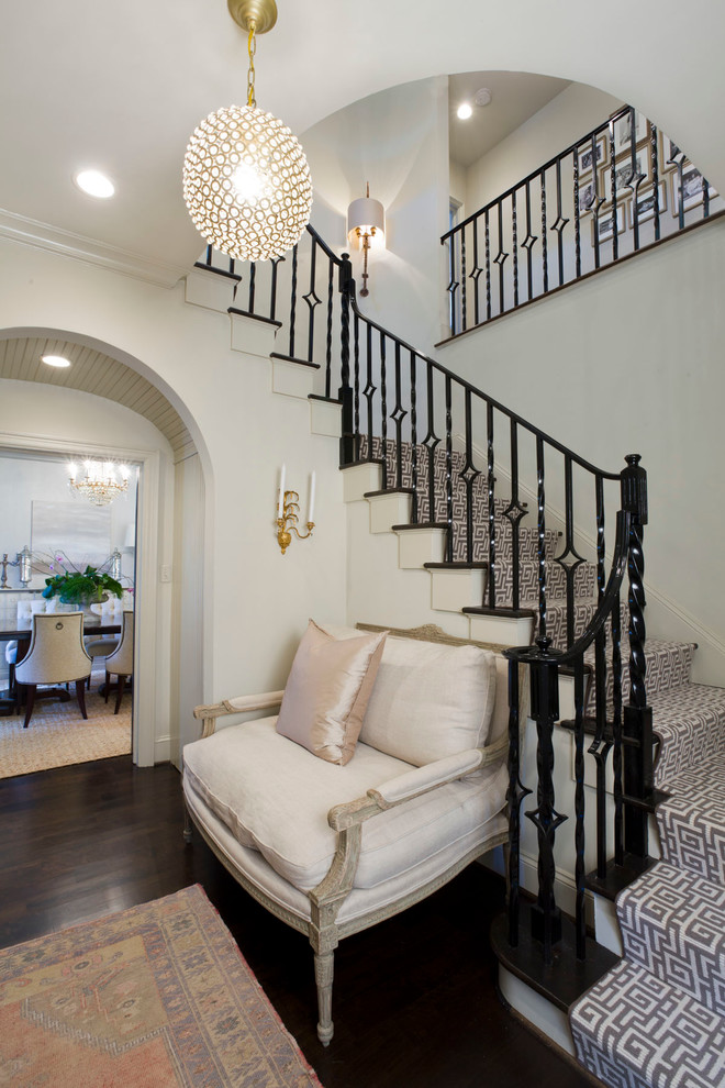 Photo of a traditional wood staircase in Charlotte with painted wood risers and feature lighting.