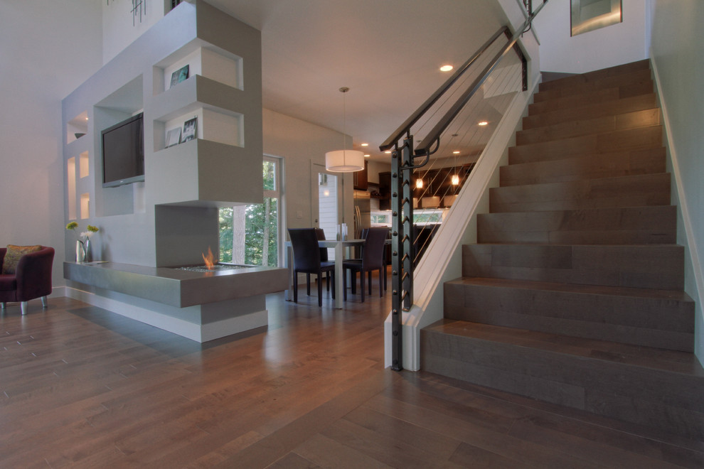 Design ideas for a medium sized modern wood u-shaped staircase in Portland with wood risers.