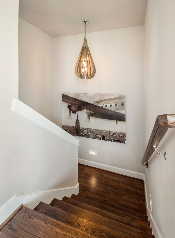 Large retro wood u-shaped staircase in Dallas with wood risers.