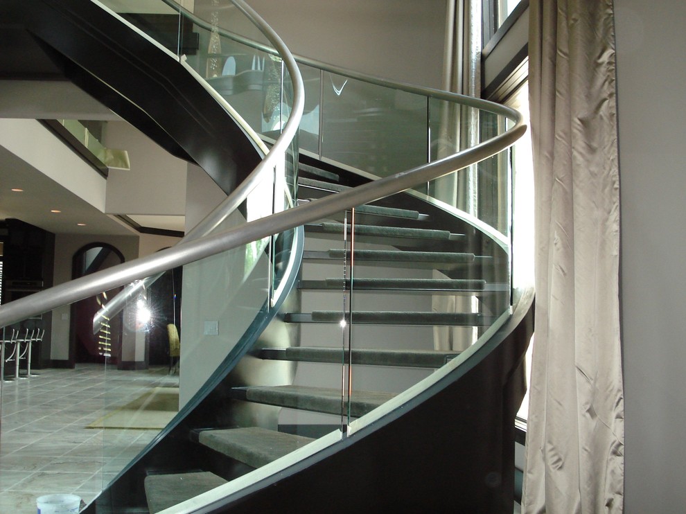 Inspiration for a large modern metal curved open staircase remodel in Dallas