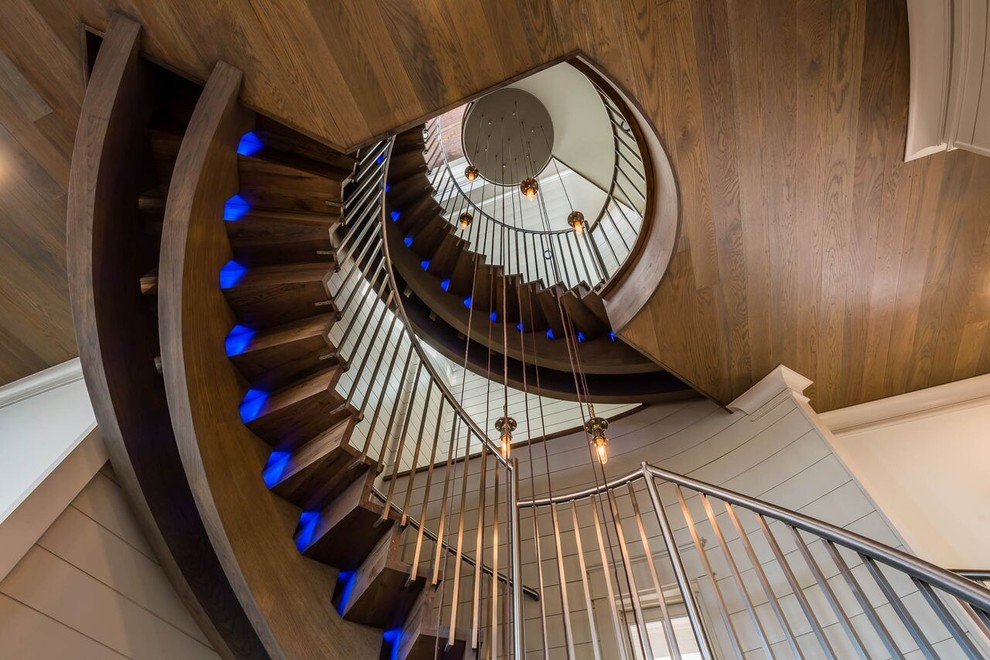 Huge trendy wooden spiral staircase photo in Miami with wooden risers