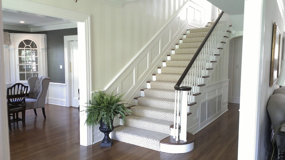 Inspiration for a medium sized classic painted wood u-shaped wood railing staircase in Newark with wood risers and wainscoting.