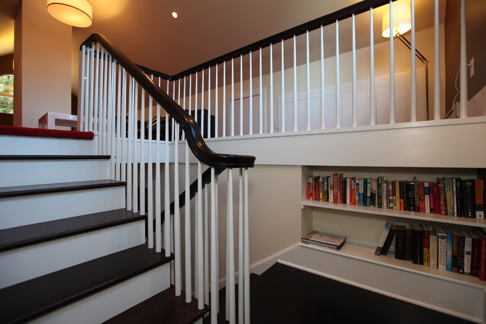 This is an example of a large classic wood u-shaped wood railing staircase in Newark with painted wood risers.