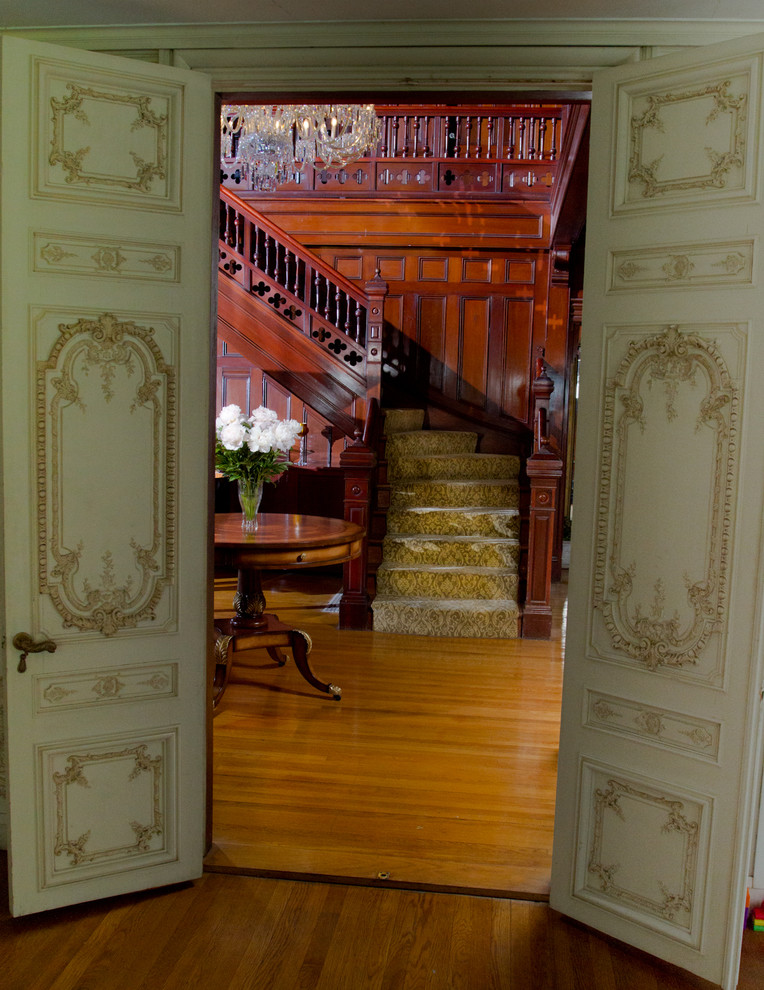 Inspiration for a large timeless carpeted l-shaped staircase remodel in Boston with wooden risers
