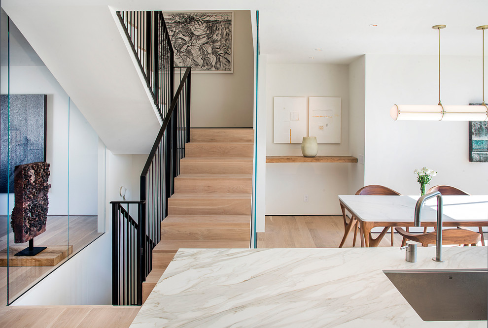 This is an example of a medium sized modern wood u-shaped mixed railing staircase in San Francisco with wood risers.