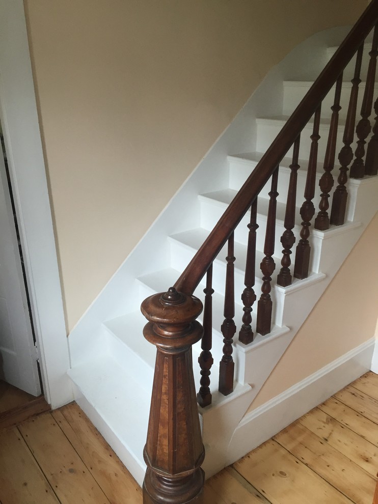 Photo of a medium sized victorian painted wood l-shaped staircase in Boston with painted wood risers.