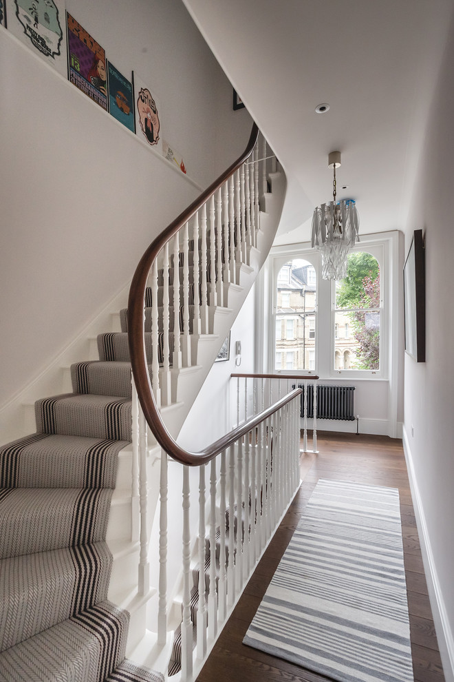 Example of a mid-sized trendy painted l-shaped wood railing staircase design in London with painted risers