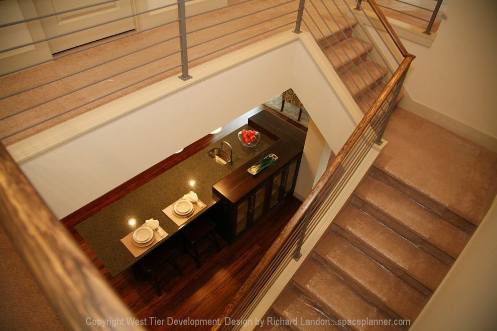 Photo of a large contemporary carpeted l-shaped staircase in Seattle with carpeted risers.