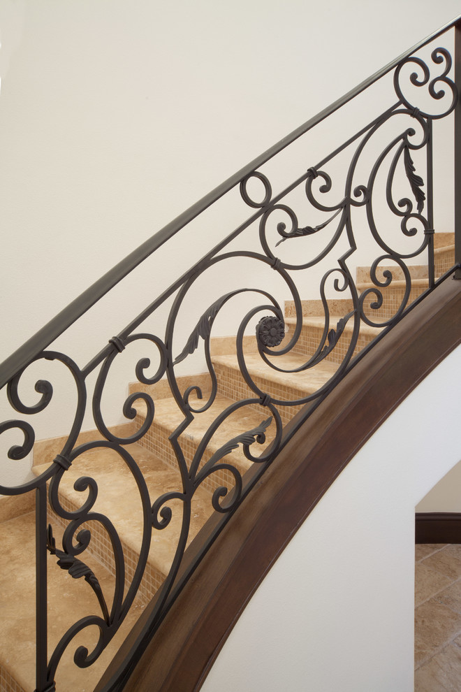 Example of a large tuscan tile curved staircase design in Orlando with tile risers