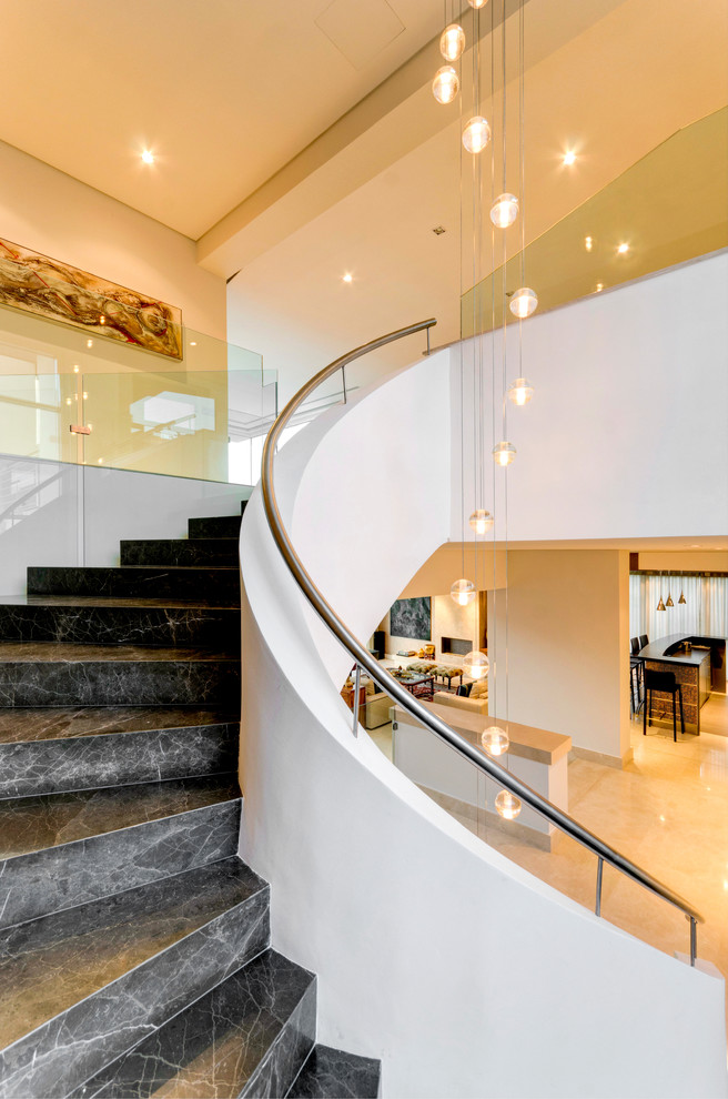 This is an example of a contemporary curved staircase in Other.
