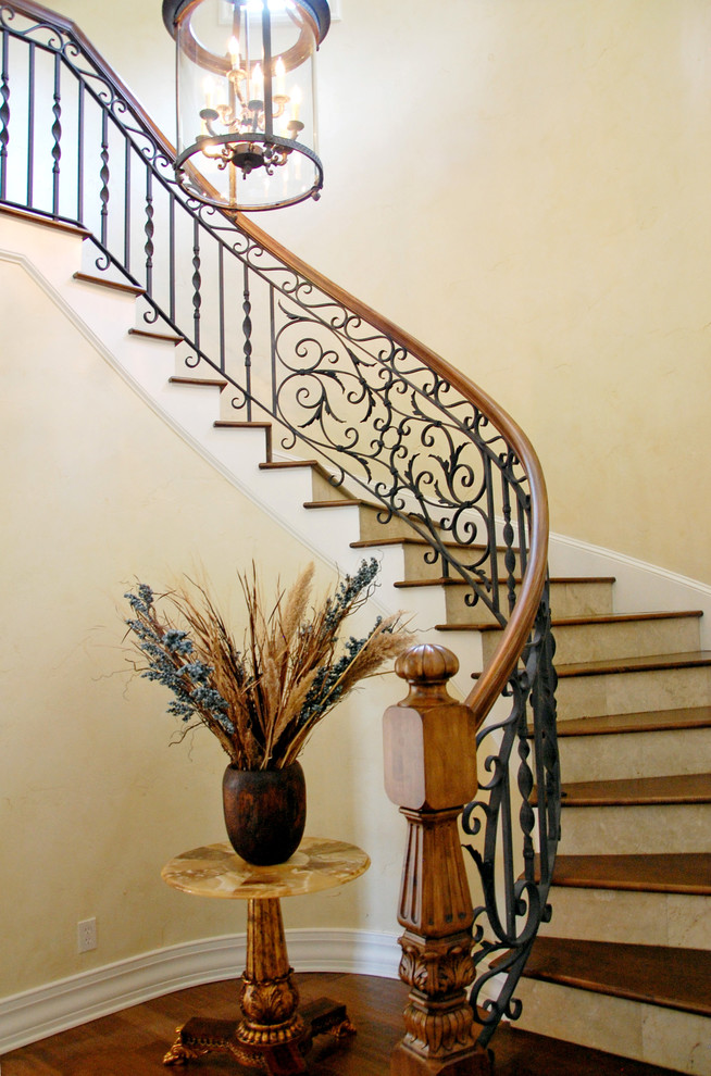 Inspiration for a medium sized mediterranean wood curved staircase in Orlando with tiled risers.