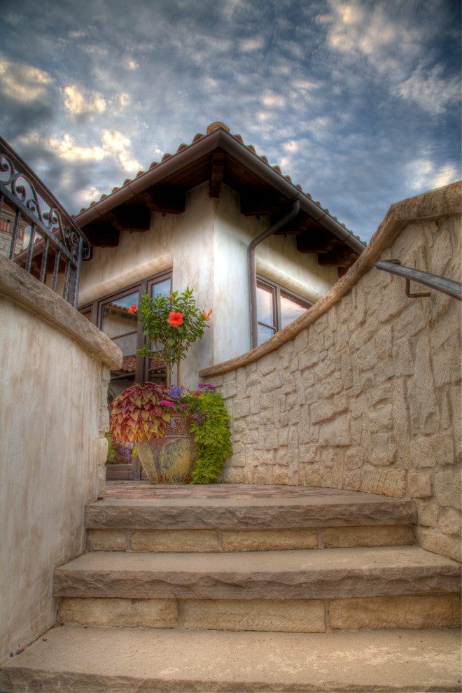 This is an example of a large mediterranean curved staircase in Denver.