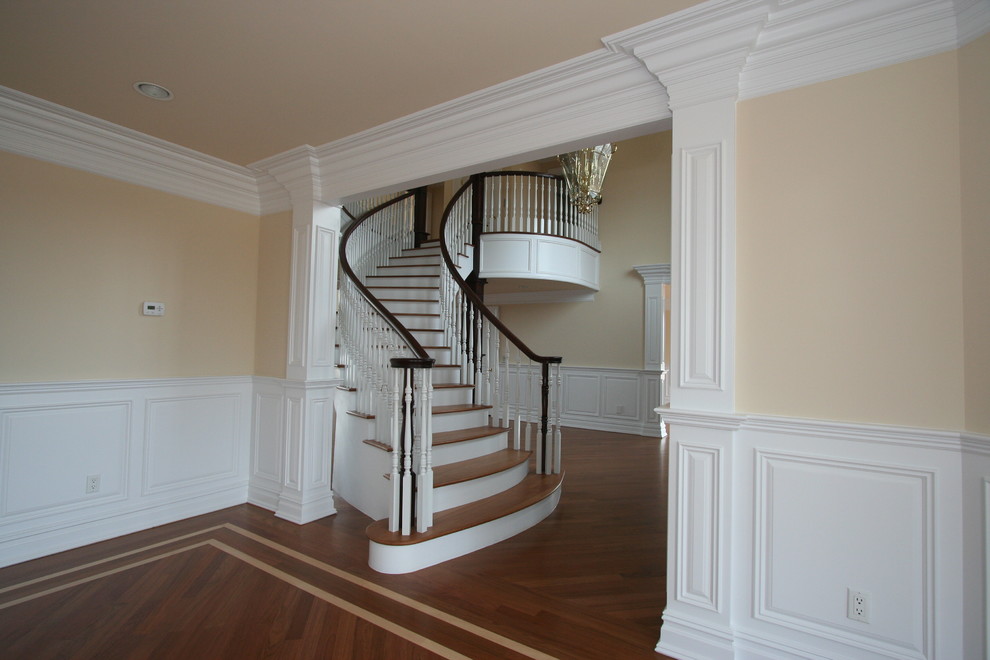 Inspiration for a medium sized victorian wood curved staircase in Philadelphia with painted wood risers.