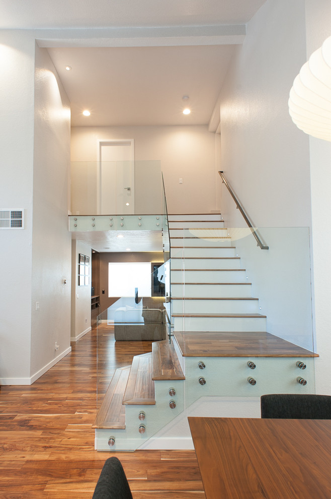 Example of a minimalist wooden l-shaped staircase design in Los Angeles with wooden risers