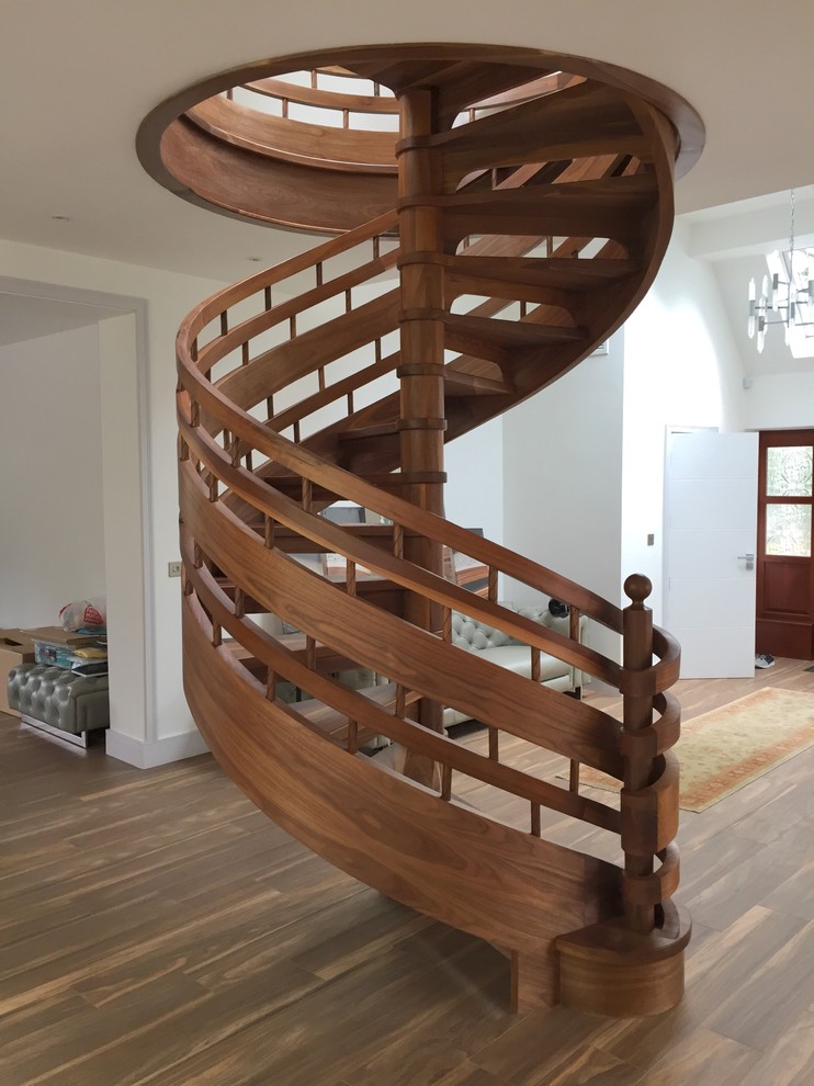 Inspiration for a medium sized contemporary wood spiral wood railing staircase in Other with wood risers.