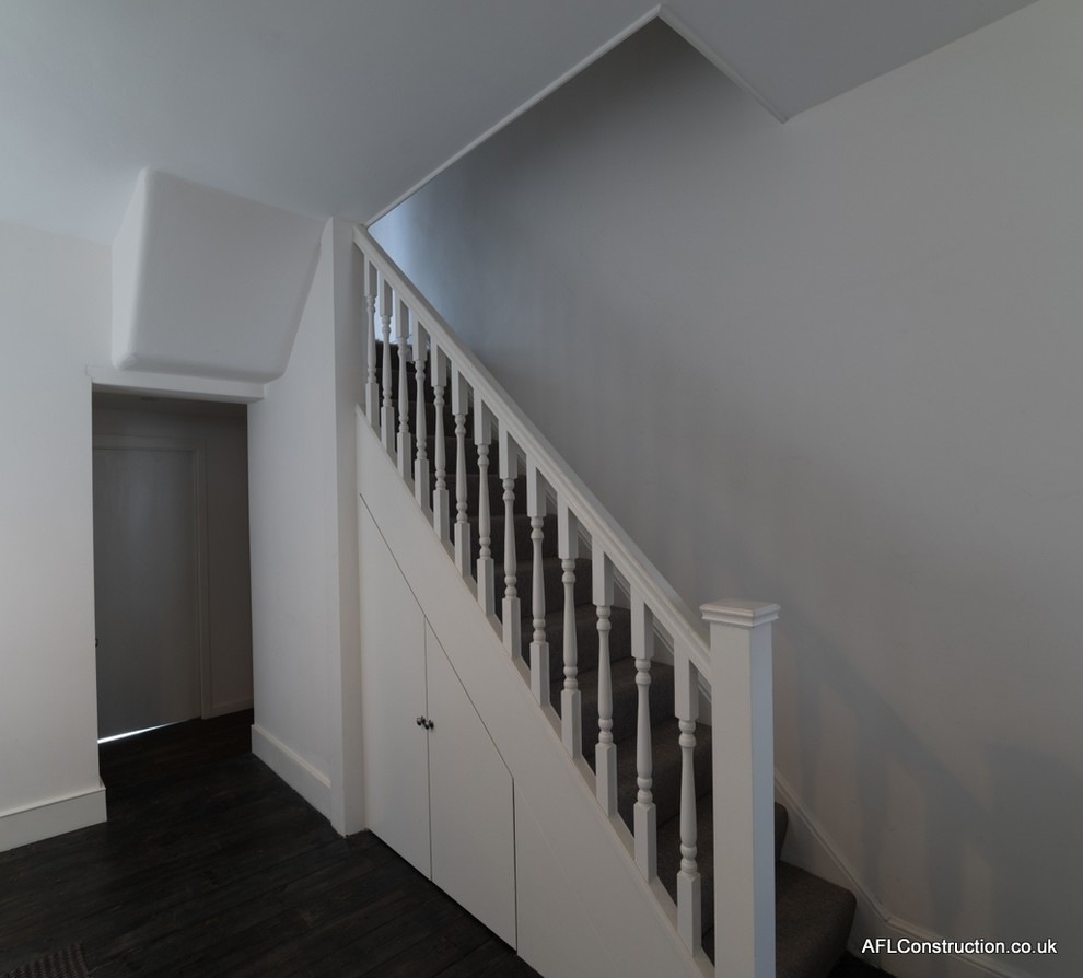 Design ideas for a small victorian carpeted straight staircase in London with carpeted risers.