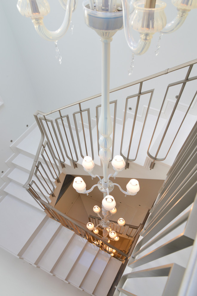 Inspiration for a large contemporary metal floating staircase remodel in London with metal risers