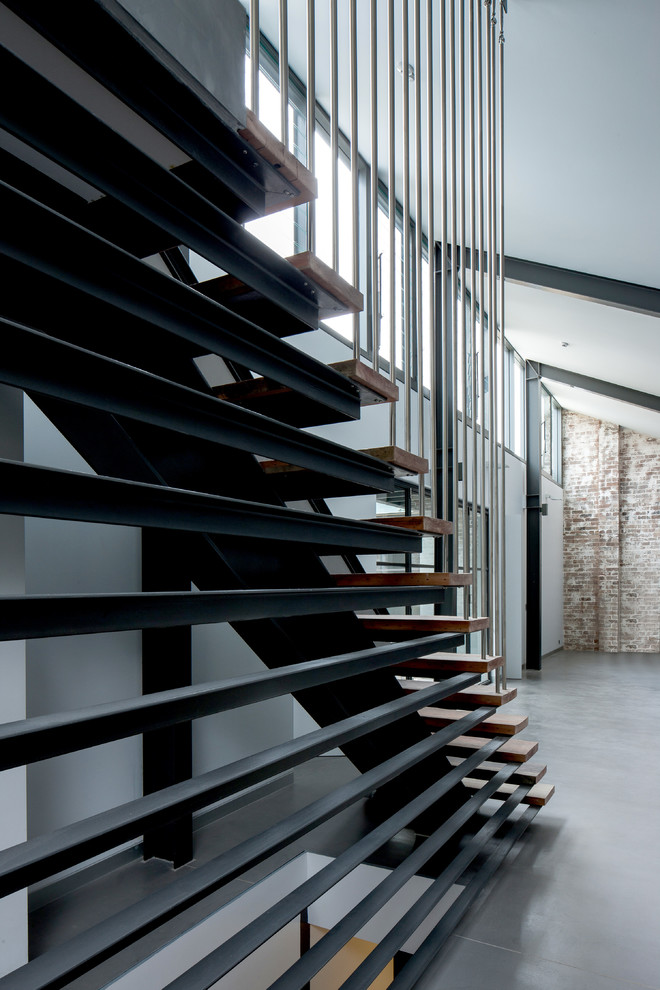 This is an example of a medium sized industrial wood straight staircase in Sydney with open risers.