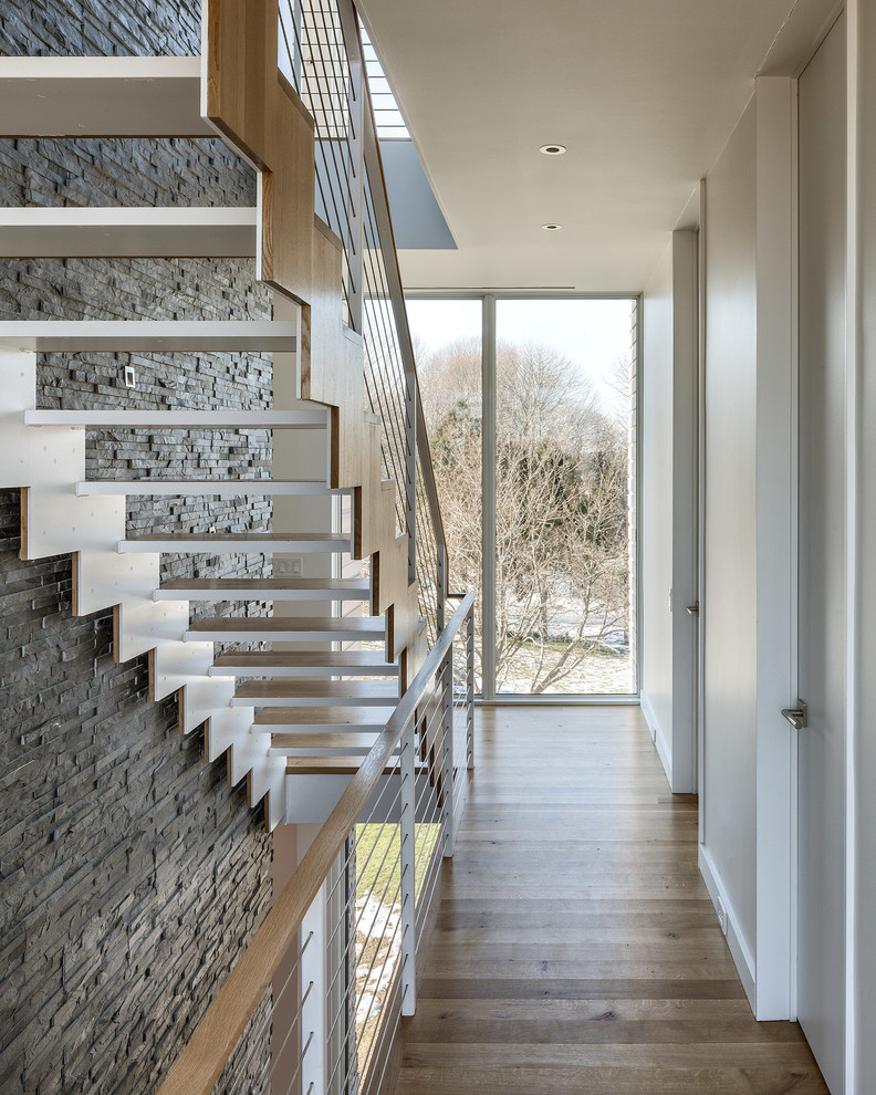 Photo of a contemporary wood straight staircase in Providence with open risers.