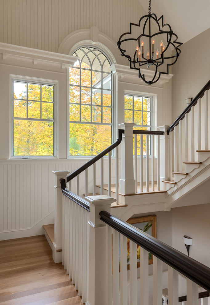 Design ideas for a coastal wood u-shaped wood railing staircase in Boston with painted wood risers.
