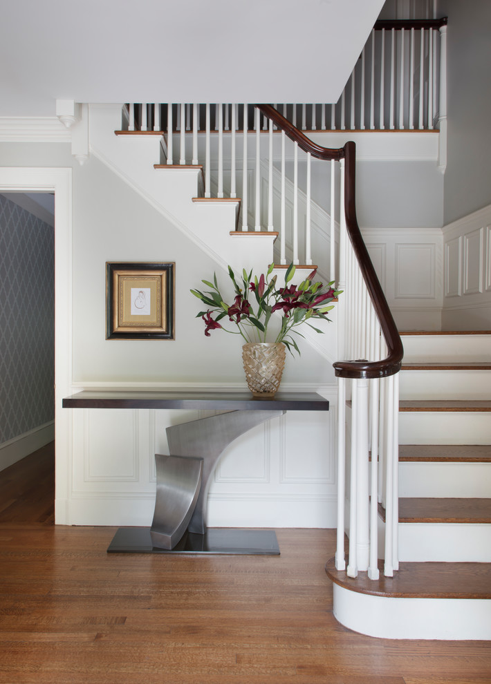 Large contemporary wood l-shaped wood railing staircase in Boston with painted wood risers.