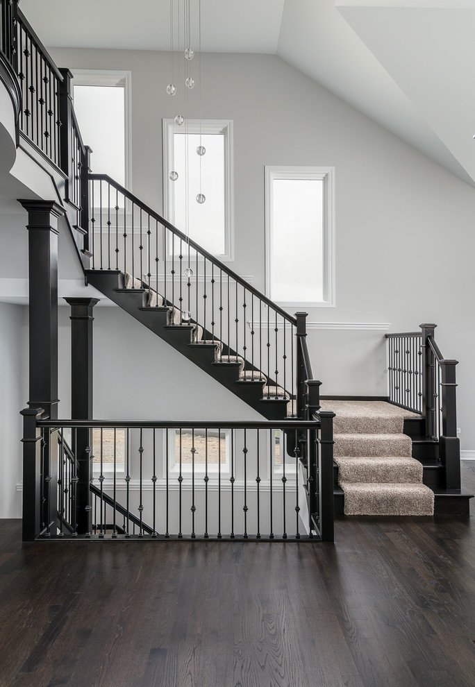 Inspiration for a large transitional wooden staircase remodel in Chicago with wooden risers