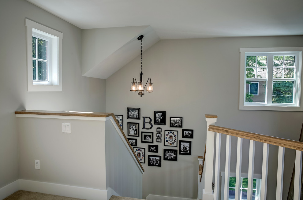 Inspiration for a mid-sized country carpeted u-shaped staircase remodel in Other with carpeted risers
