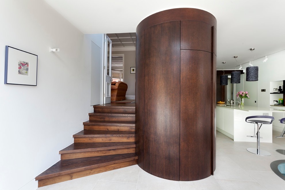 Mid-sized trendy wooden spiral staircase photo in London with wooden risers
