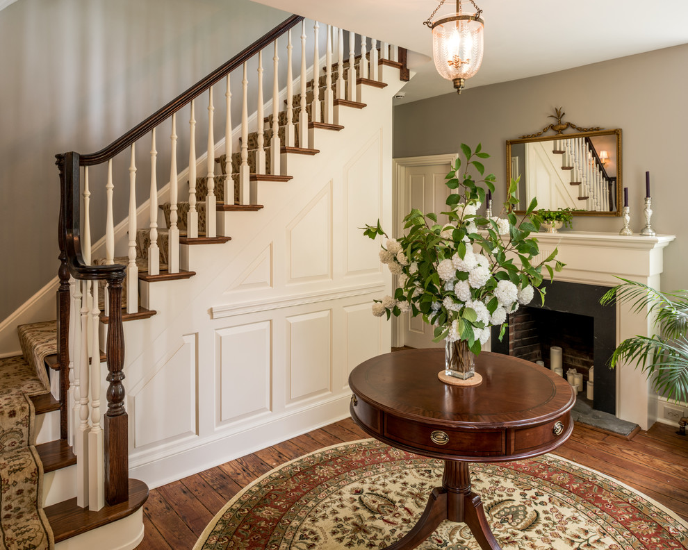 Medium sized traditional wood l-shaped staircase in Philadelphia with painted wood risers.