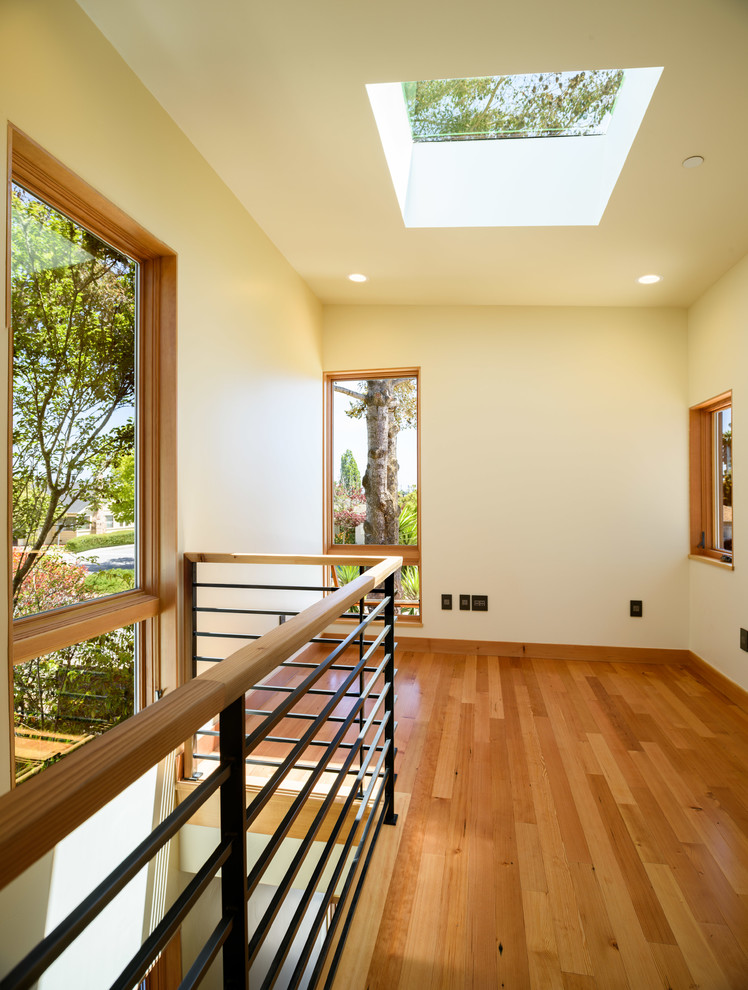 This is an example of a medium sized contemporary wood straight wood railing staircase in San Francisco with metal risers.