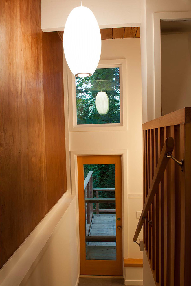 Example of a mid-sized mid-century modern wooden straight staircase design in Vancouver with wooden risers