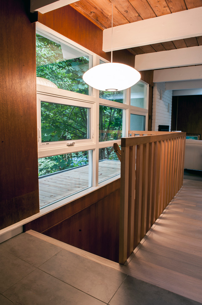 Inspiration for a mid-sized mid-century modern wooden straight staircase remodel in Vancouver with wooden risers