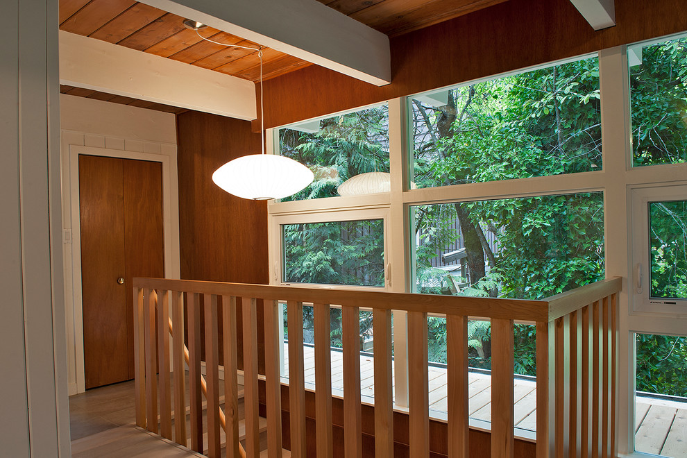 Example of a mid-sized mid-century modern wooden straight staircase design in Vancouver with wooden risers