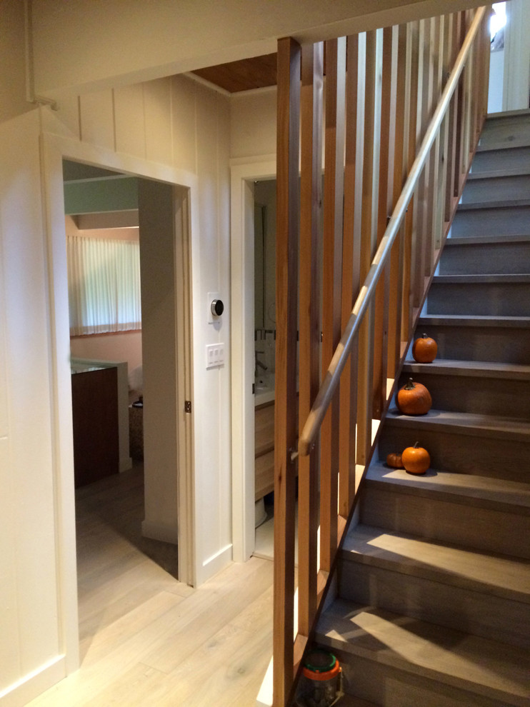 Inspiration for a mid-sized mid-century modern wooden straight staircase remodel in Vancouver with wooden risers