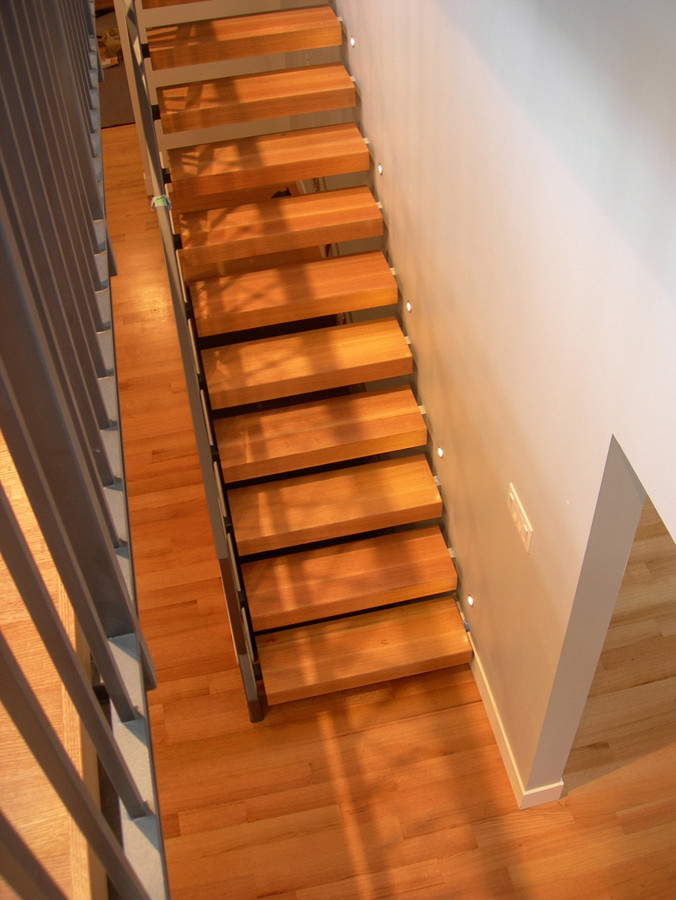 Photo of a contemporary wood straight staircase in Vancouver with open risers.