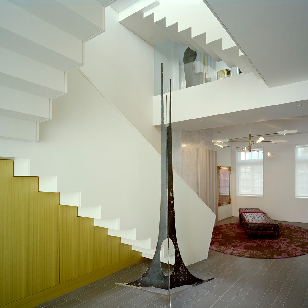 Photo of a medium sized contemporary l-shaped staircase in New York with under stair storage.