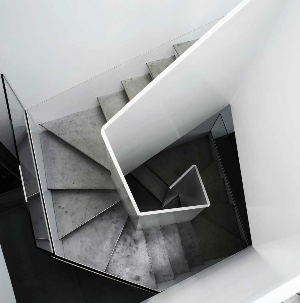 Стильный дизайн: большая винтовая лестница в стиле модернизм с металлическими ступенями и стеклянными перилами - последний тренд