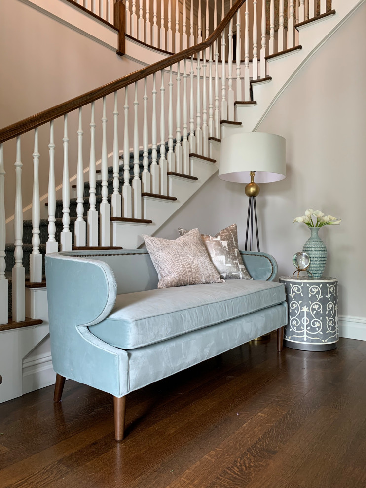 Medium sized classic carpeted curved wood railing staircase in New York with carpeted risers.